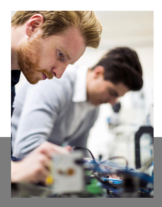Two engineers working on electronics components s