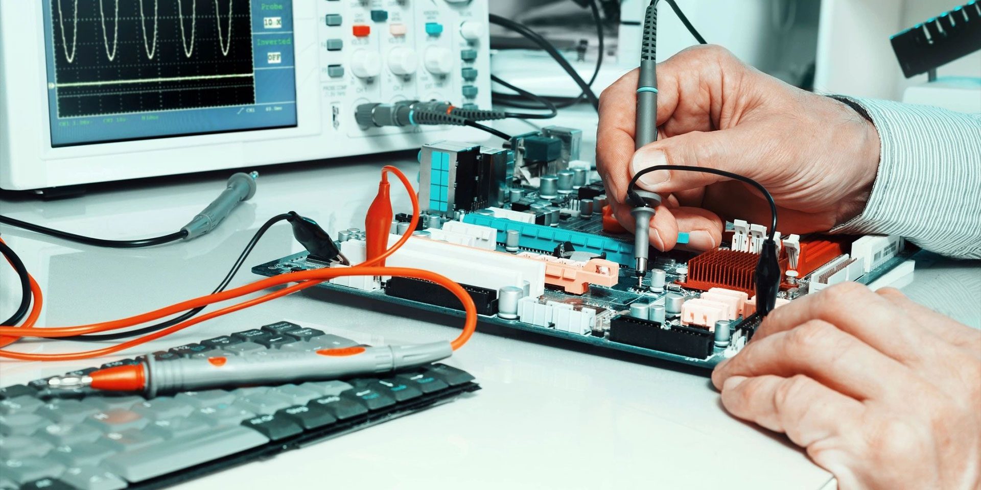 Hands of tech reparing an electronic circuit