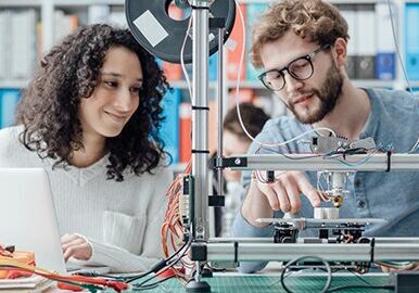 Engineering students using a 3D printer in the laboratory,